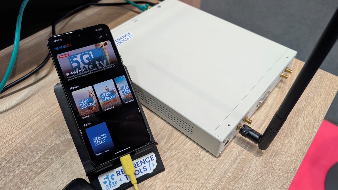 5G Broadcast Reference Tools transmitter hardware, with a phone running the 5G-MAGflix demo app